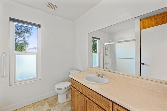 bathroom with a shower with shower door, vanity, and toilet