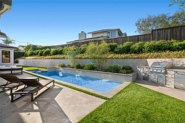 view of swimming pool with area for grilling, pool water feature, a patio area, an in ground hot tub, and grilling area