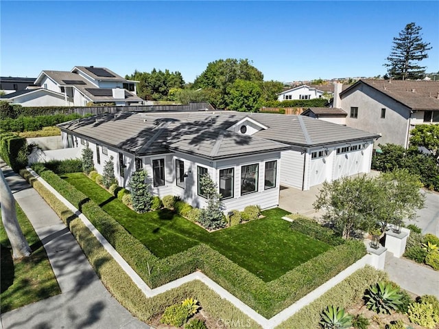 back of house featuring a garage and a yard