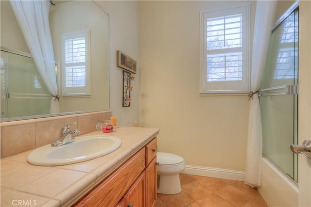 full bathroom with toilet, vanity, tile patterned flooring, and shower / bath combination with glass door