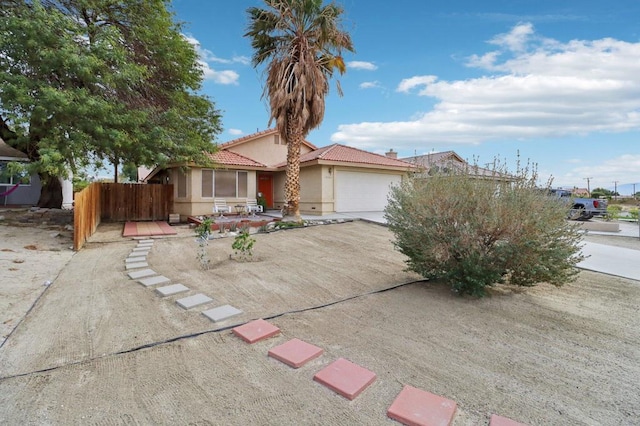 view of front of property featuring a garage and a patio