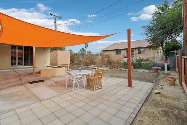 view of patio featuring a storage unit