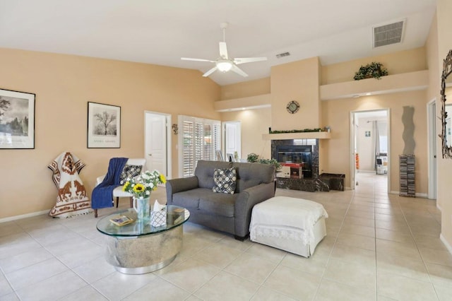 living room with lofted ceiling, light tile patterned floors, and a premium fireplace