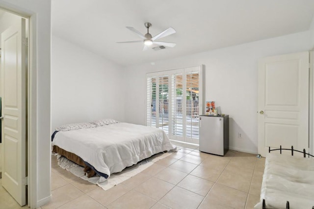 tiled bedroom featuring ceiling fan and stainless steel refrigerator