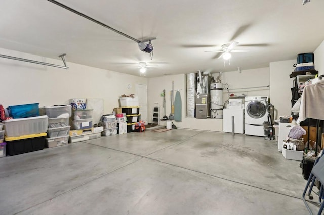 garage with a garage door opener, separate washer and dryer, and strapped water heater