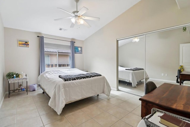 bedroom featuring ceiling fan, light tile patterned floors, a closet, and vaulted ceiling