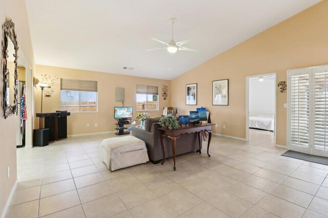 tiled living room featuring ceiling fan and lofted ceiling