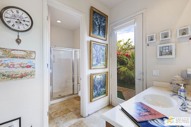 bathroom with walk in shower and vanity