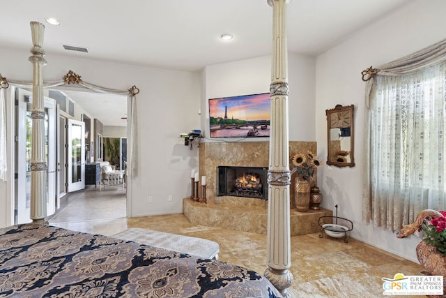 bedroom featuring a premium fireplace