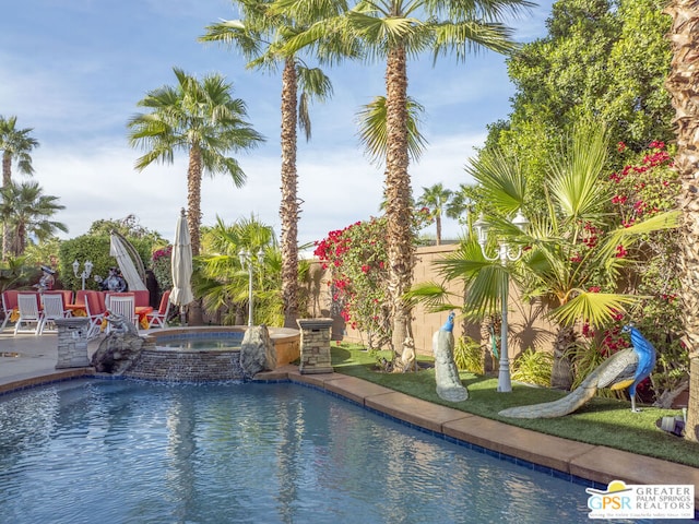 view of pool featuring a patio and an in ground hot tub