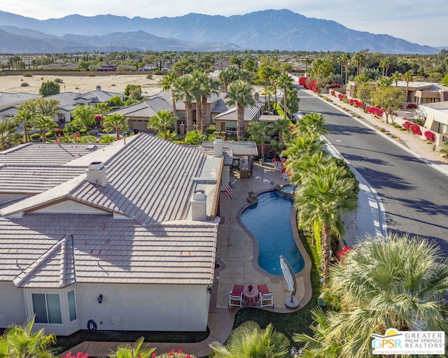 birds eye view of property featuring a mountain view