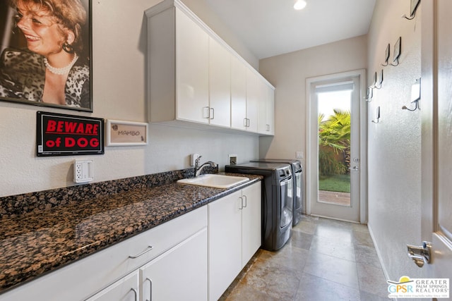 laundry area with washer and dryer, cabinets, a wealth of natural light, and sink