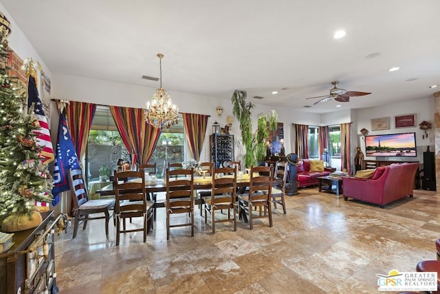 dining room featuring a healthy amount of sunlight and ceiling fan with notable chandelier