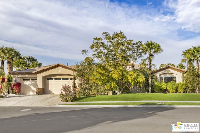 view of front facade with a front lawn and a garage