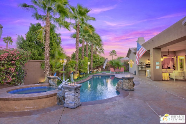 pool at dusk with an in ground hot tub, a patio area, and ceiling fan