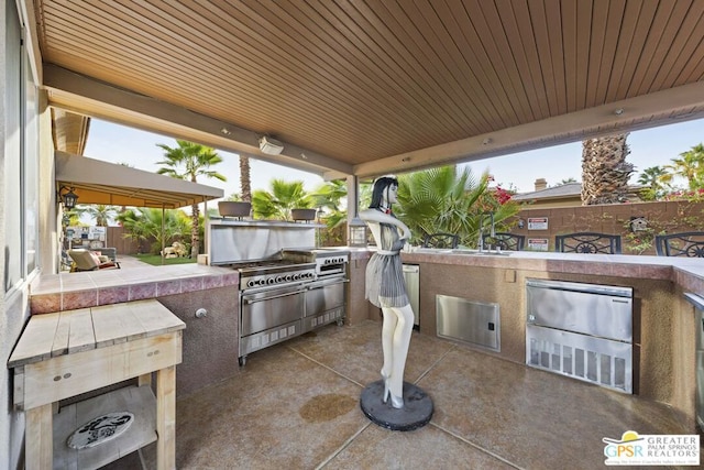 view of patio with an outdoor kitchen and area for grilling