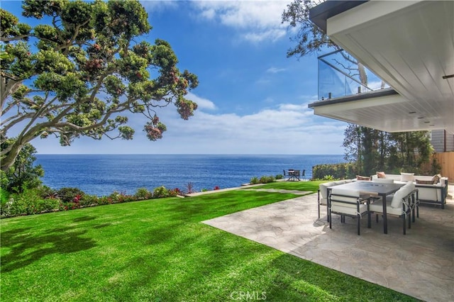 view of yard with a water view and a patio area