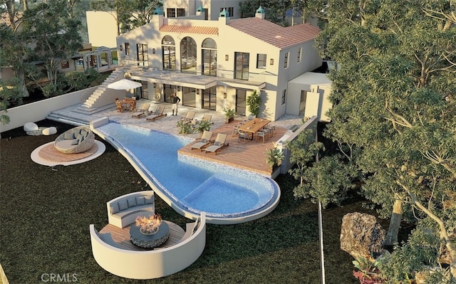 view of swimming pool with a patio area and an outdoor fire pit