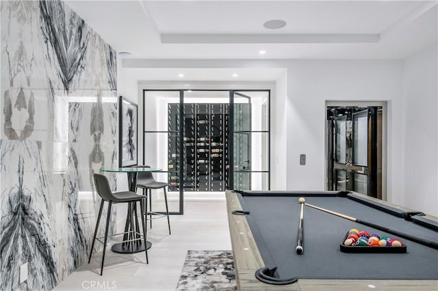 recreation room featuring a raised ceiling and billiards