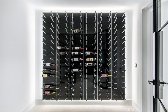 wine cellar with electric panel and hardwood / wood-style floors