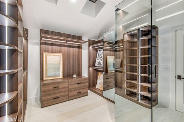 walk in closet featuring vaulted ceiling