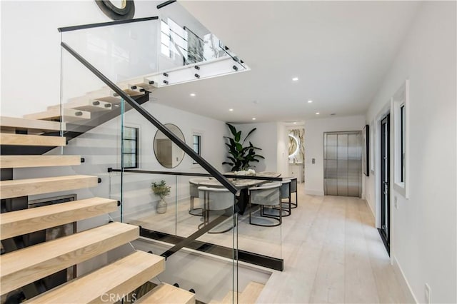 staircase featuring hardwood / wood-style floors and elevator