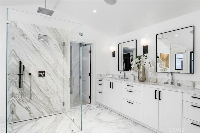 bathroom with walk in shower, vanity, and vaulted ceiling