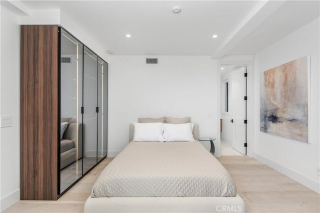 bedroom featuring light hardwood / wood-style flooring and a closet