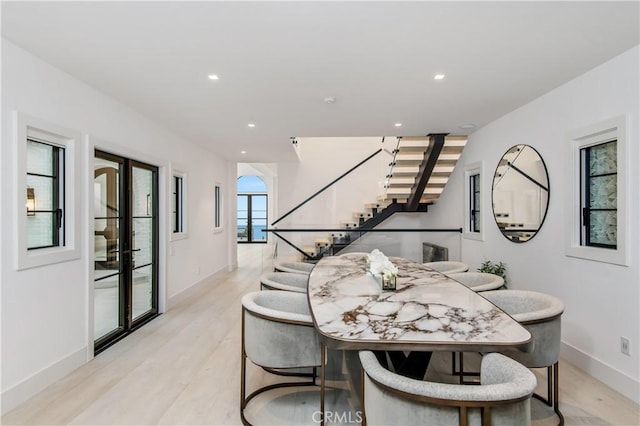 dining area featuring light hardwood / wood-style floors and french doors