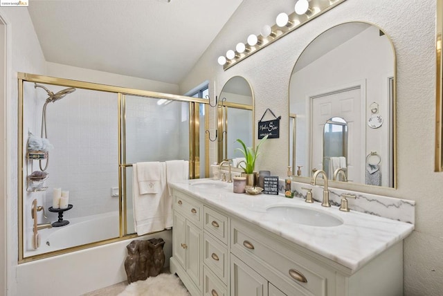 bathroom with enclosed tub / shower combo, vaulted ceiling, and vanity