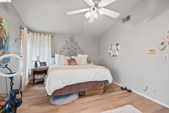 bedroom with vaulted ceiling, ceiling fan, and light hardwood / wood-style floors