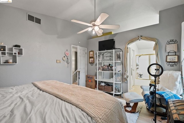 bedroom with ceiling fan and light hardwood / wood-style flooring