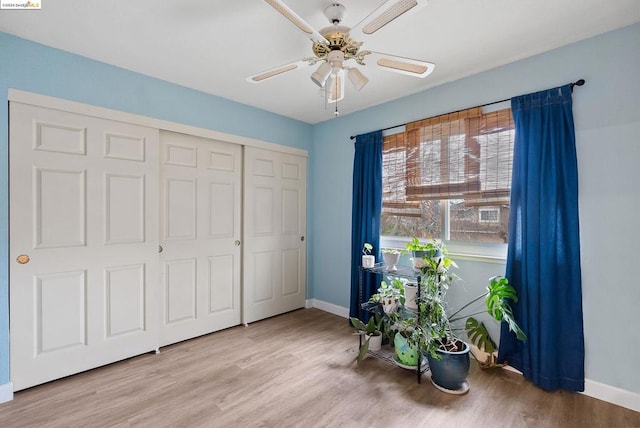 unfurnished room with ceiling fan and light wood-type flooring