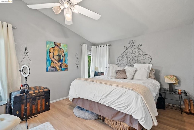 bedroom featuring lofted ceiling, ceiling fan, and light hardwood / wood-style flooring