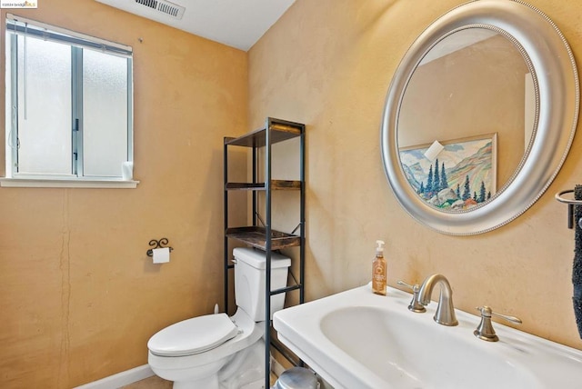 bathroom featuring sink and toilet