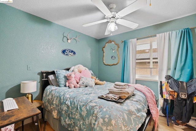 bedroom with hardwood / wood-style flooring and ceiling fan