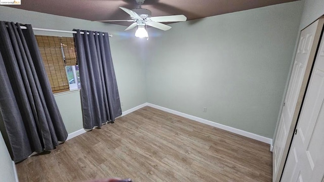 spare room with ceiling fan and light wood-type flooring