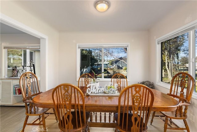 dining area with plenty of natural light and wood finished floors