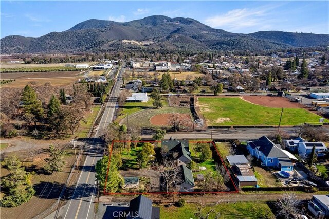 birds eye view of property with a mountain view