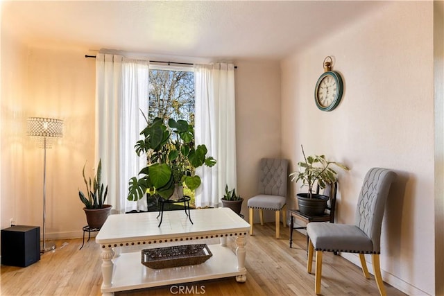 sitting room with light wood-type flooring and baseboards