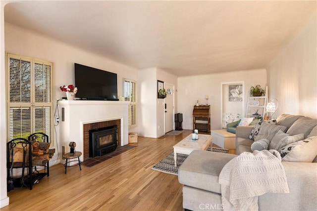 living room featuring a fireplace and light wood-style flooring