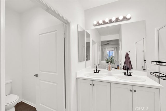 bathroom featuring vanity, ceiling fan, and toilet