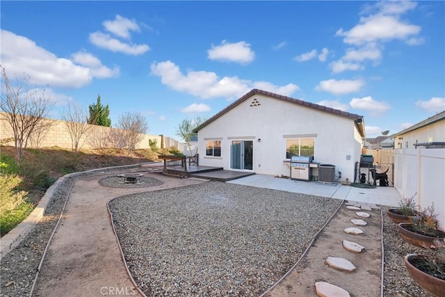 rear view of property featuring cooling unit and a patio