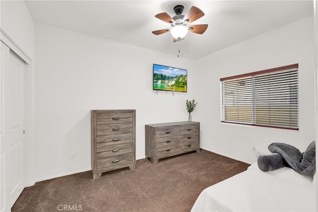 carpeted bedroom with ceiling fan and a closet