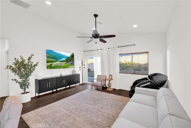 living room featuring ceiling fan, dark hardwood / wood-style floors, and high vaulted ceiling