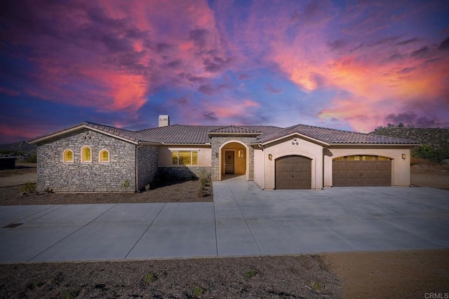 mediterranean / spanish-style home featuring a garage