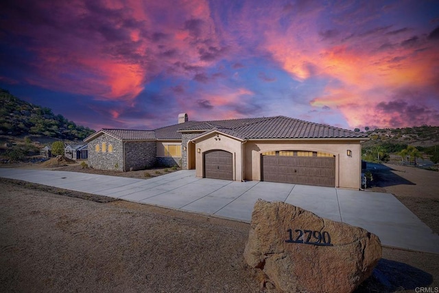 mediterranean / spanish home featuring a garage