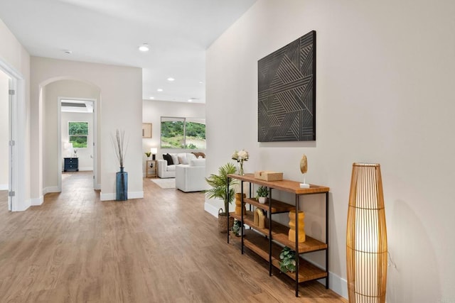 corridor with hardwood / wood-style flooring