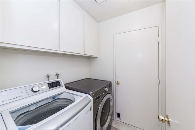 laundry room featuring cabinets and independent washer and dryer