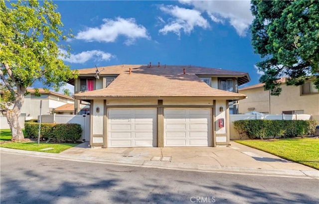 front facade with a garage and a front lawn